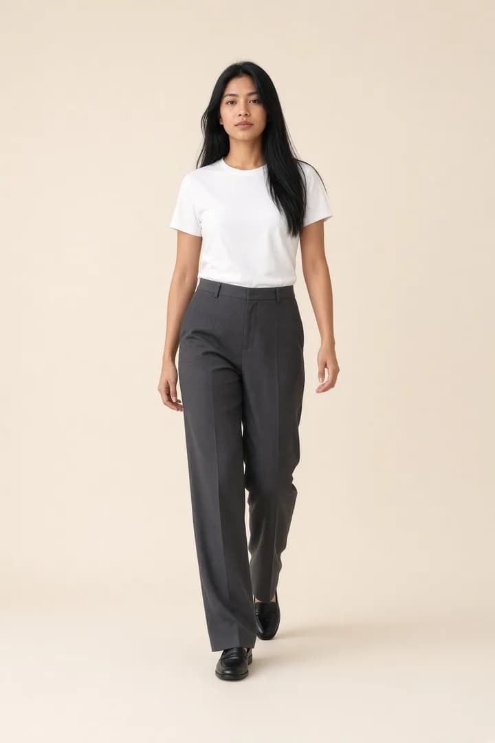Model walking in a white T-shirt and charcoal trousers